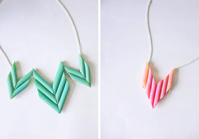 Two macaroni necklaces are shown. One is teal and the other is pink and both are on actual chains.