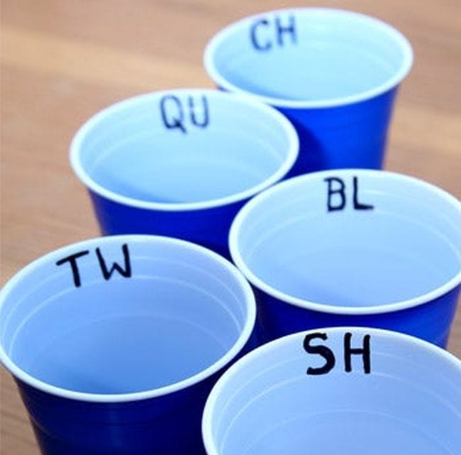 Blue plastic cups with letter blends written on the inside rim