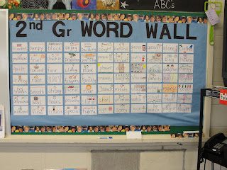 a second grade word wall with hand-drawn vocabulary cards