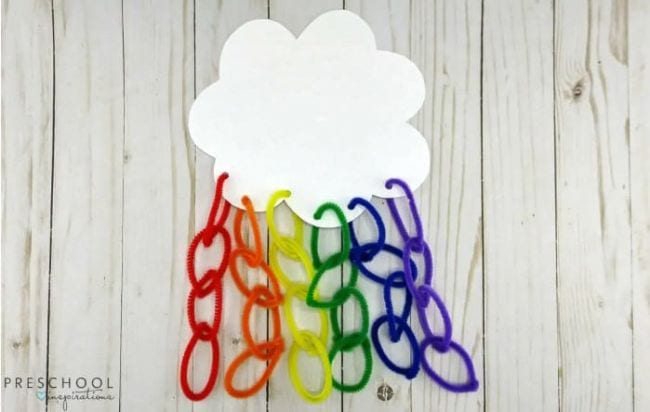 Cloud with rainbow-colored pipe cleaners hanging from it