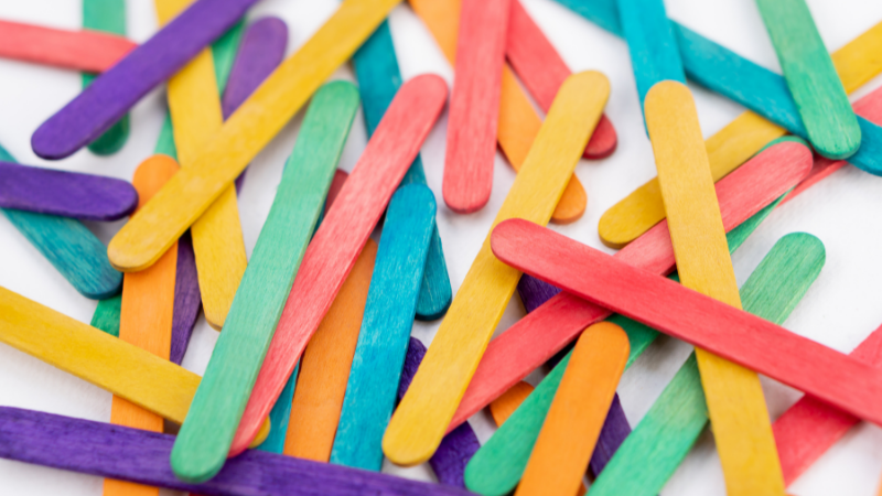Brightly colored popsicle sticks on a white background