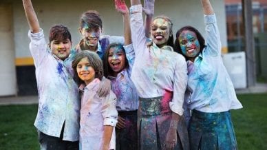group of students with colorful paint on their faces and clothing - motivating students