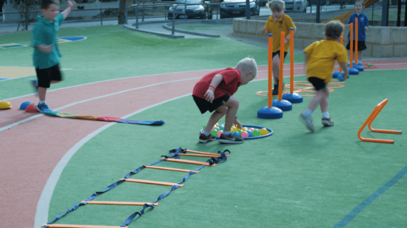 Students are shown retrieving balls from a circle in the middle of an obstacle course.