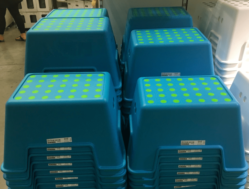 Bright blue and green step stools in stacks