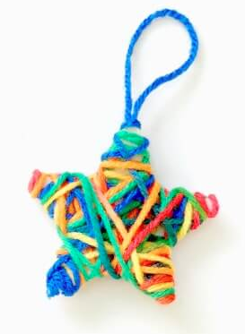 Star ornament winter crafts for the classroom wrapped in colorful yarn.