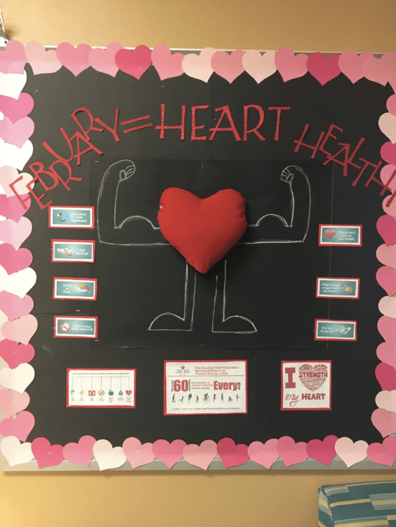Bulletin board with a muscular body flexing with a heart as a face and words February= Heart Health- February Bulletin Boards