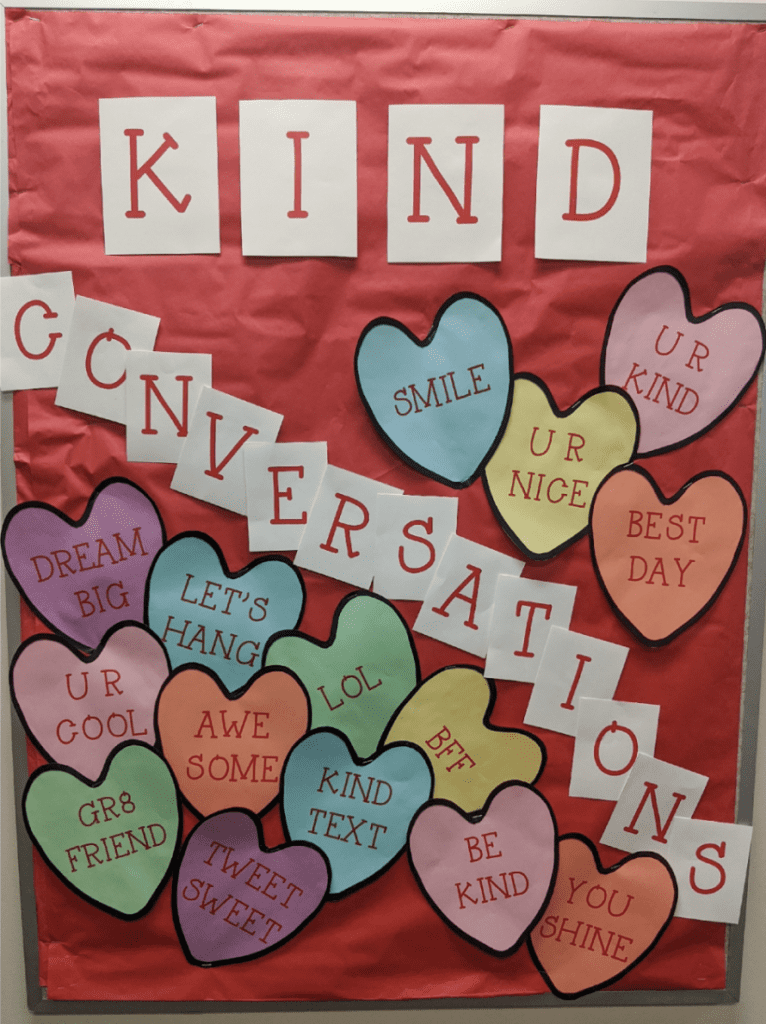 Bulletin board of heart cutouts and words Kind Conversations