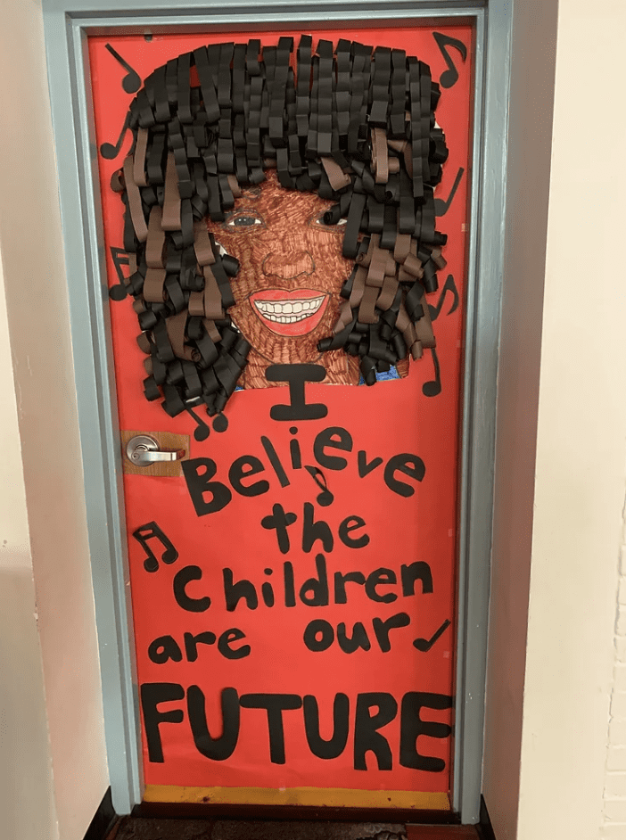Door with words I believe in the children of our future and drawing of Whitney Houston