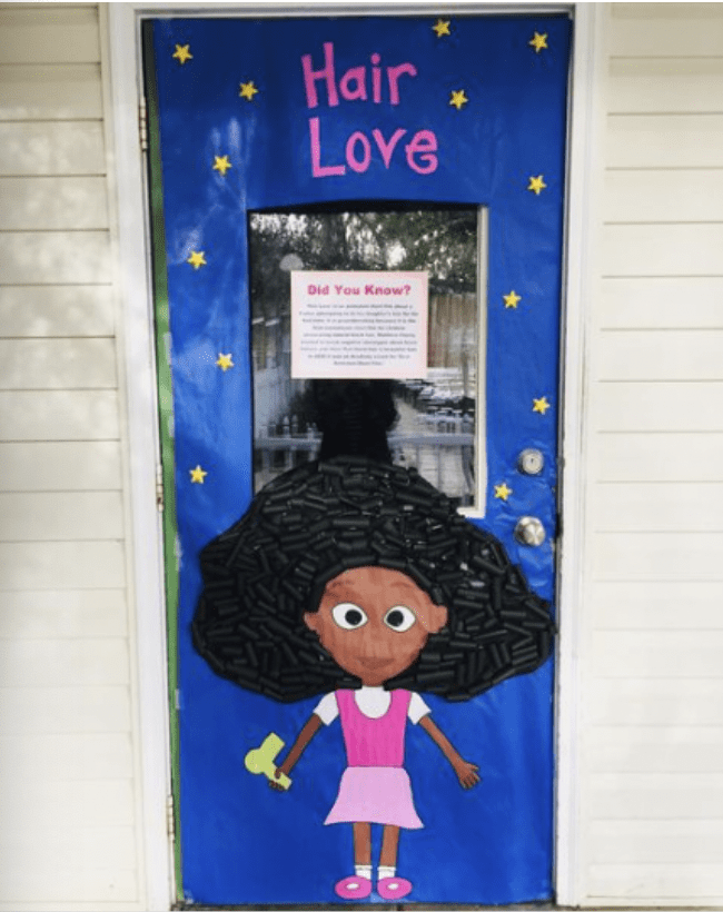 Door with words Hair Love and a drawing of a young girl