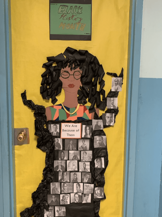 Door with young woman and many photos of Black History month icons on her shirt