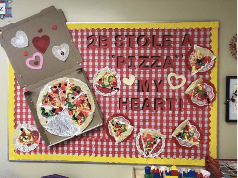 Bulletin board with cutout of pizza and words 2B stole a pizza my heart!