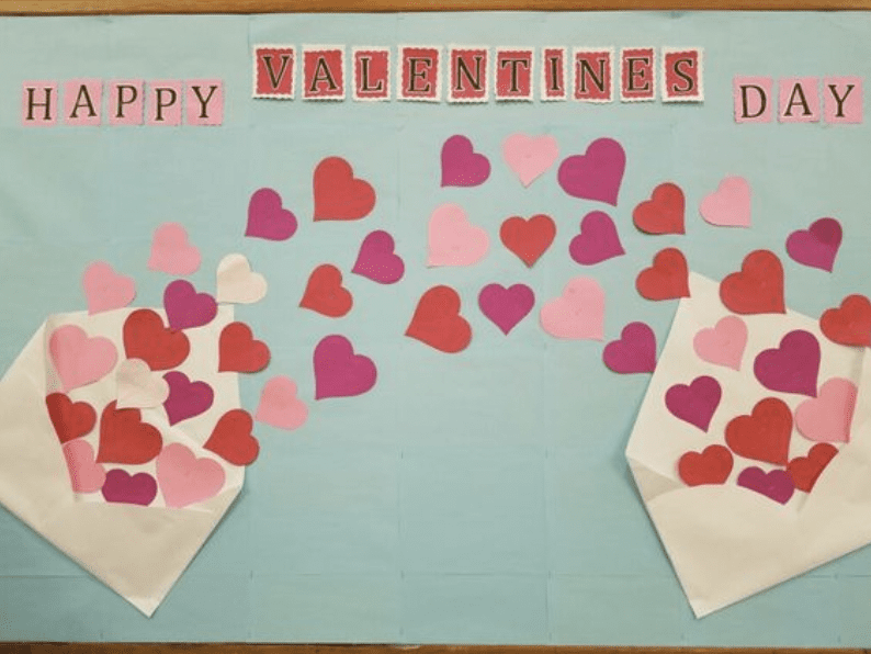 Board with cutouts of hearts and words Happy Valentines Day!