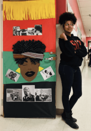 Still of Black History month door with women standing next to it