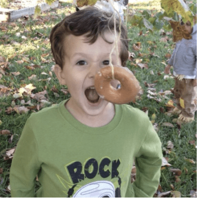 Kid eating donut off a string