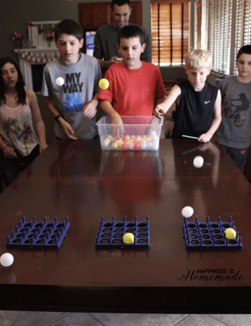 Kid playing ping pong tic tac toe, as an example of minute to win it games for kids