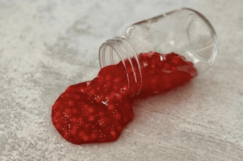 Red slime pouring out of a mason jar