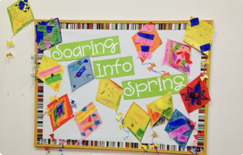 Bulletin board with kites and words Soaring into Spring