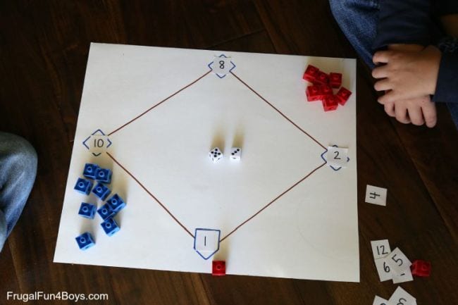 Baseball diamond drawn on a large piece of paper, with numbers at each base and red and blue markers (Second Grade Math Games)