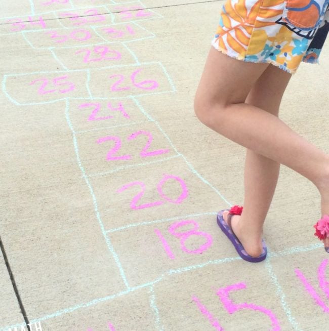 Second grade math student playing hopscotch 