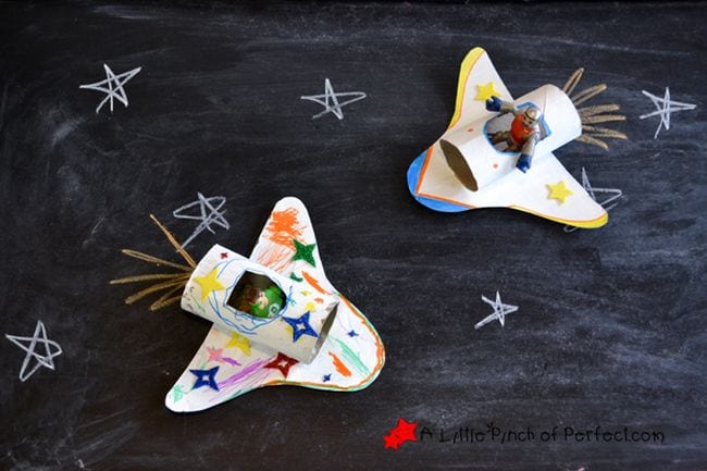 colorful homemade space shuttles made from toilet paper tubes and scraps of cardboard