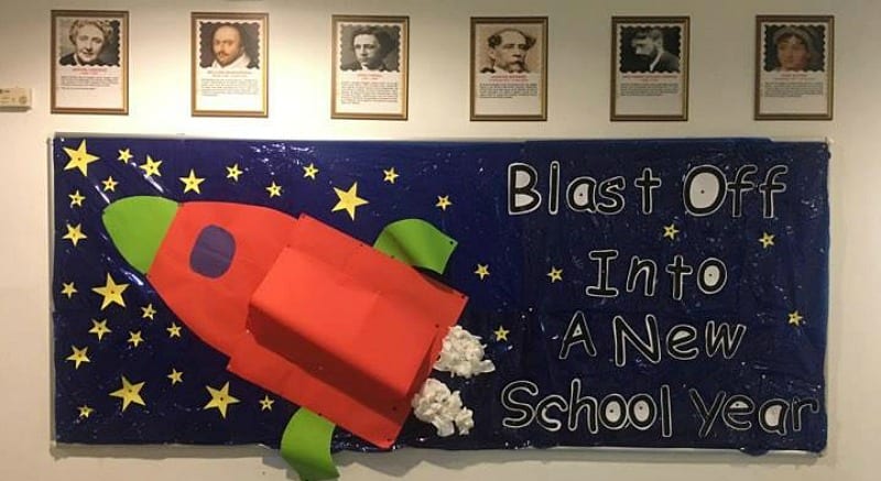 Bulletin board with a 3-D rocket ship made of paper. Text reads Blast Off into a new school year.
