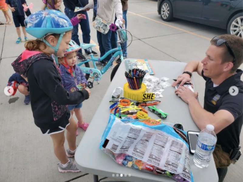 Children talking with police officer during St. Jude TrikeAThon