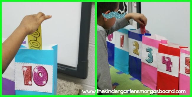 a student dropping a piece of paper into numbered colorful paper bags 