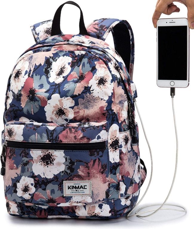 Floral patterned backpack with external charging port and hand holding smartphone, as an example of the best teacher backpacks