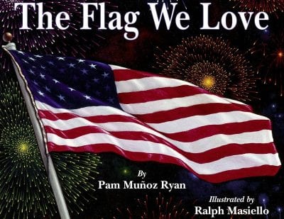 Book cover of The Flag We Love with an American flag waving with fireworks in the background