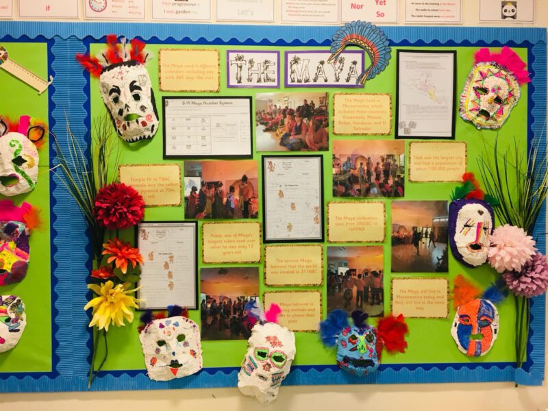 October bulletin board ideas include Indigenous People like this one honoring the Maya. Handmade masks surround images with informational text.