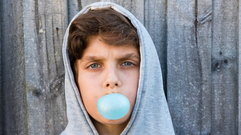 Student blowing a gum bubble.