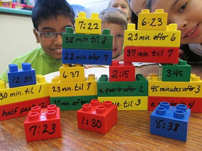 Students stacking Duplo blocks with times written on them (Third Grade Math Games)