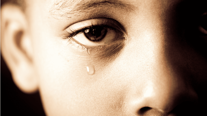 Close up of boy crying - childhood trauma