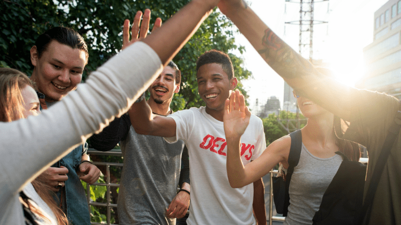 Teens high-fiving