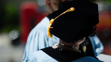 woman in graduation attire - doctorate in education