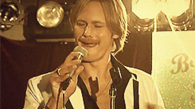 Man singing into microphone.