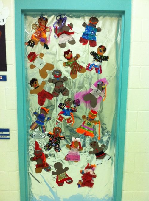 Classroom door decorated with foil to look like a baking pan, with individually decorated gingerbread men