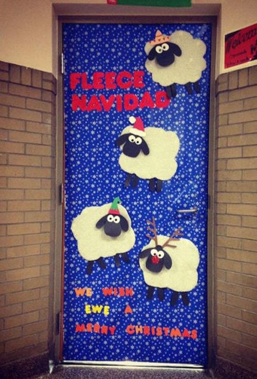 Classroom door decorated with large lambs and text reading Fleece Navidad: We Wish Ewe a Merry Christmas