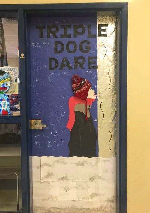 Classroom door decorated with a boy with his tongue stuck to a flagpole, with text reading Triple Dog Dare