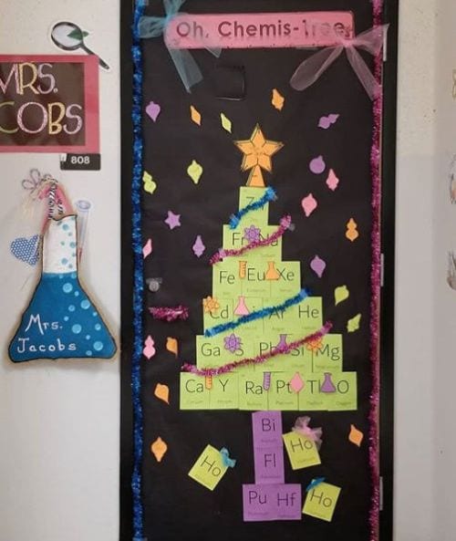 Classroom door decorated with a Christmas tree made of parts of the periodic table, with text reading Oh, Chemis-tree