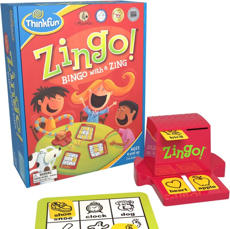 A box shows cartoon children smiling big while playing a game. It says Zingo on it (educational board games)