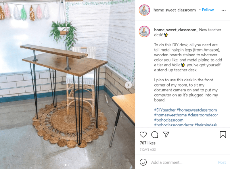 In the corner of a classroom is a DIY desk made from parts ordered from Amazon, wooden boards, and pipe.