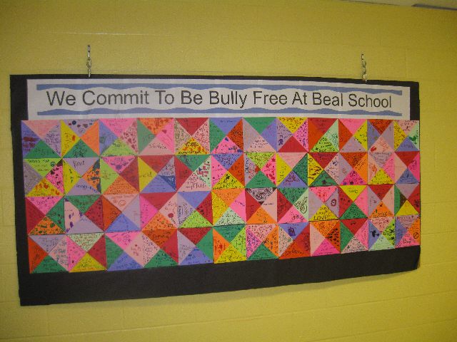October bulletin board ideas include this one that says "We commit to be bully free at Beal School. The bottom is made up of all different colored triangles with anti-bullying sentiments on them.