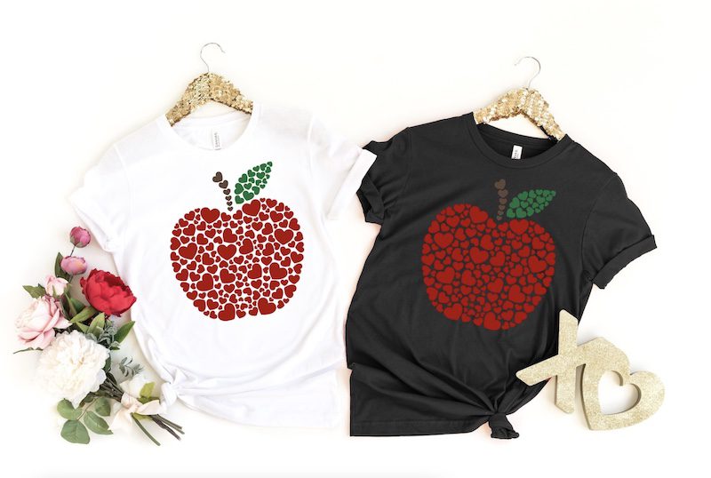 White and black t-shirts with red apples made from heart shapes