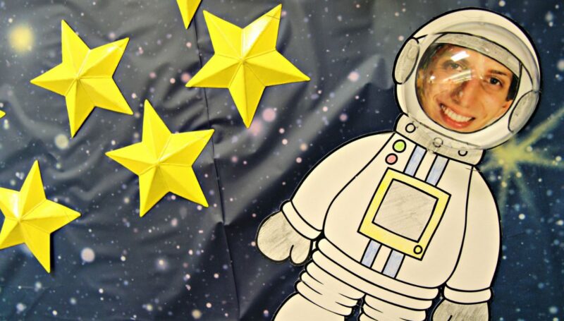 Bulletin board with stars and astronaut with photo of teacher's face and a plastic helmet