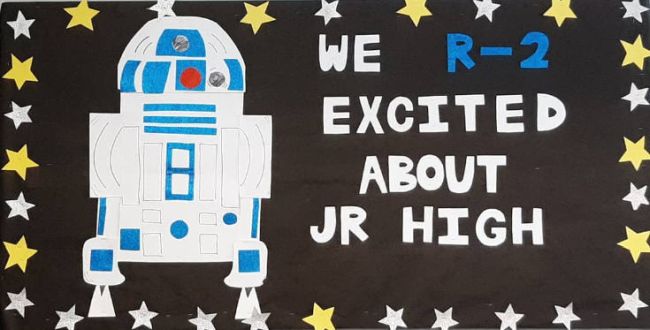 Bulletin board with R2D2 robot. Text reads "We R-2 excited about jr. high"