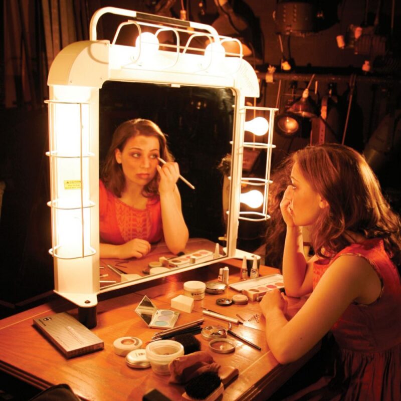 Teen girl theater student putting on makeup backstage using the Backstage Make-up Station