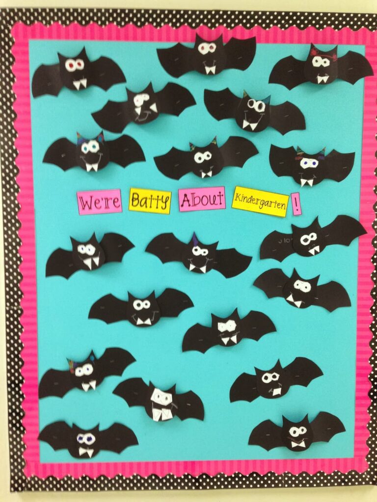 Fall bulletin boards can include Halloween ones like this teal background with bats all over it. Text reads "we're batty about kindergarten." 