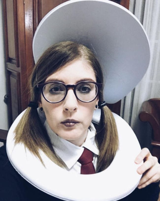 Woman dressed in Harry Potter robes with a toilet seat around her neck (Book Character Costume Ideas)