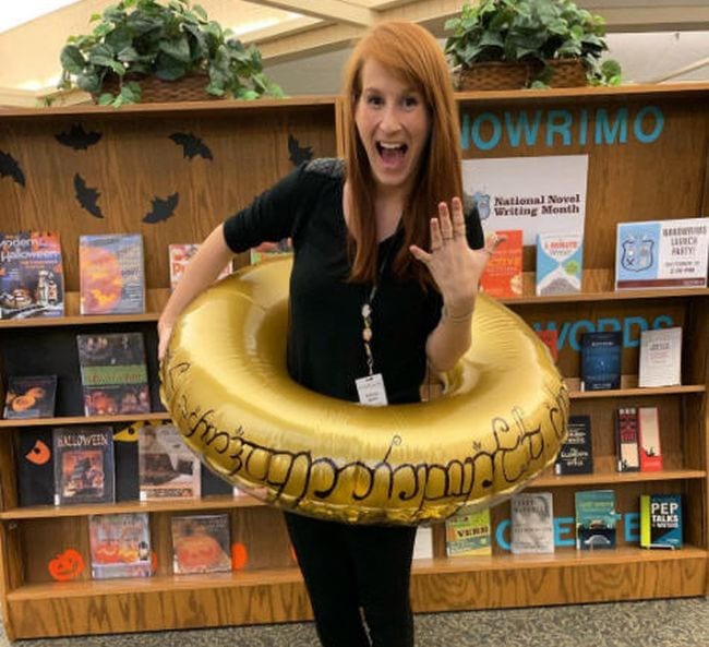 Woman wearing an inflatable gold pool ring with Lord of the Rings inscription